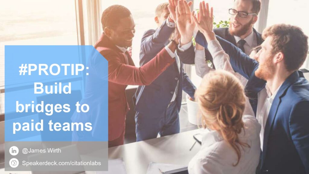 Group of professionals high-fiving in an office with the text '#PROTIP: Build bridges to paid teams' overlaid on the image. Includes James Wirth’s social media and speakerdeck.com links